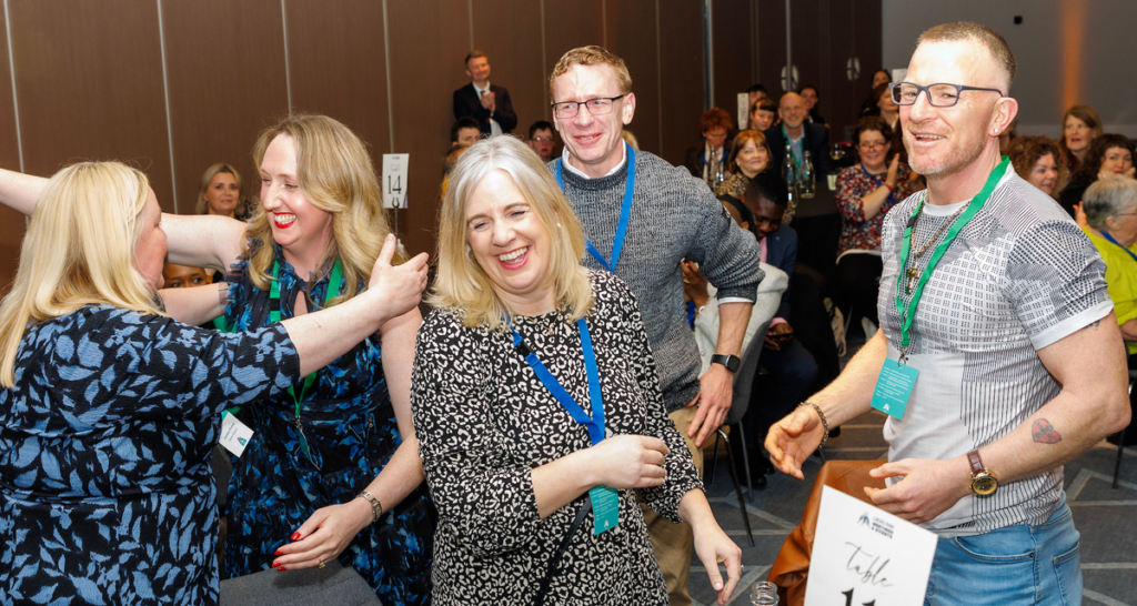 Cork Simon Community learners and staff hug each other immediately after winning the AONTAS STAR Award
