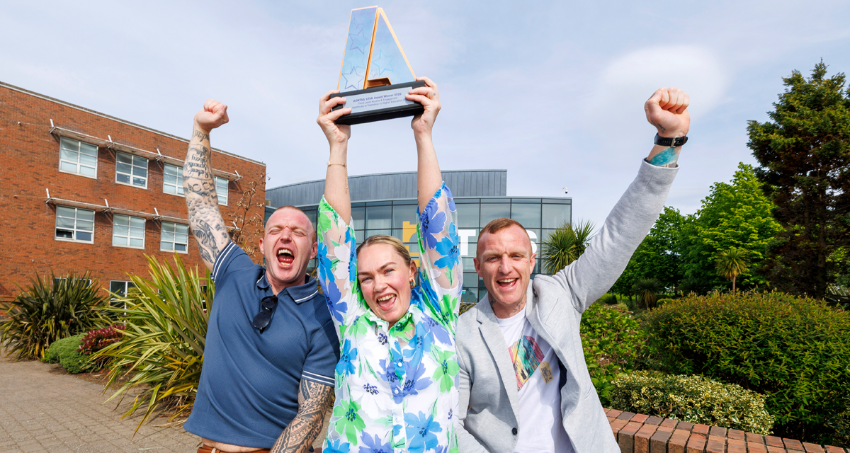 Learners from TUS celebrate outside TUS in Limerick holding up their AONTAS STAR Award, laughing with fists in the air