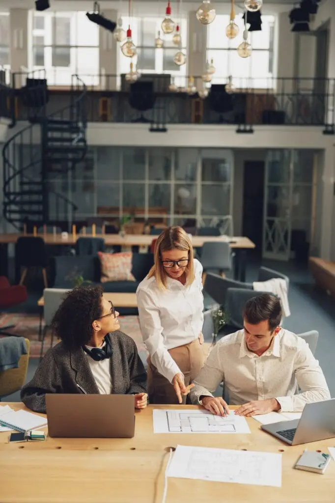 Group of business colleagues working together on project in modern coworking space
